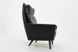Lænestol i sort læder med høj ryg, dansk design
