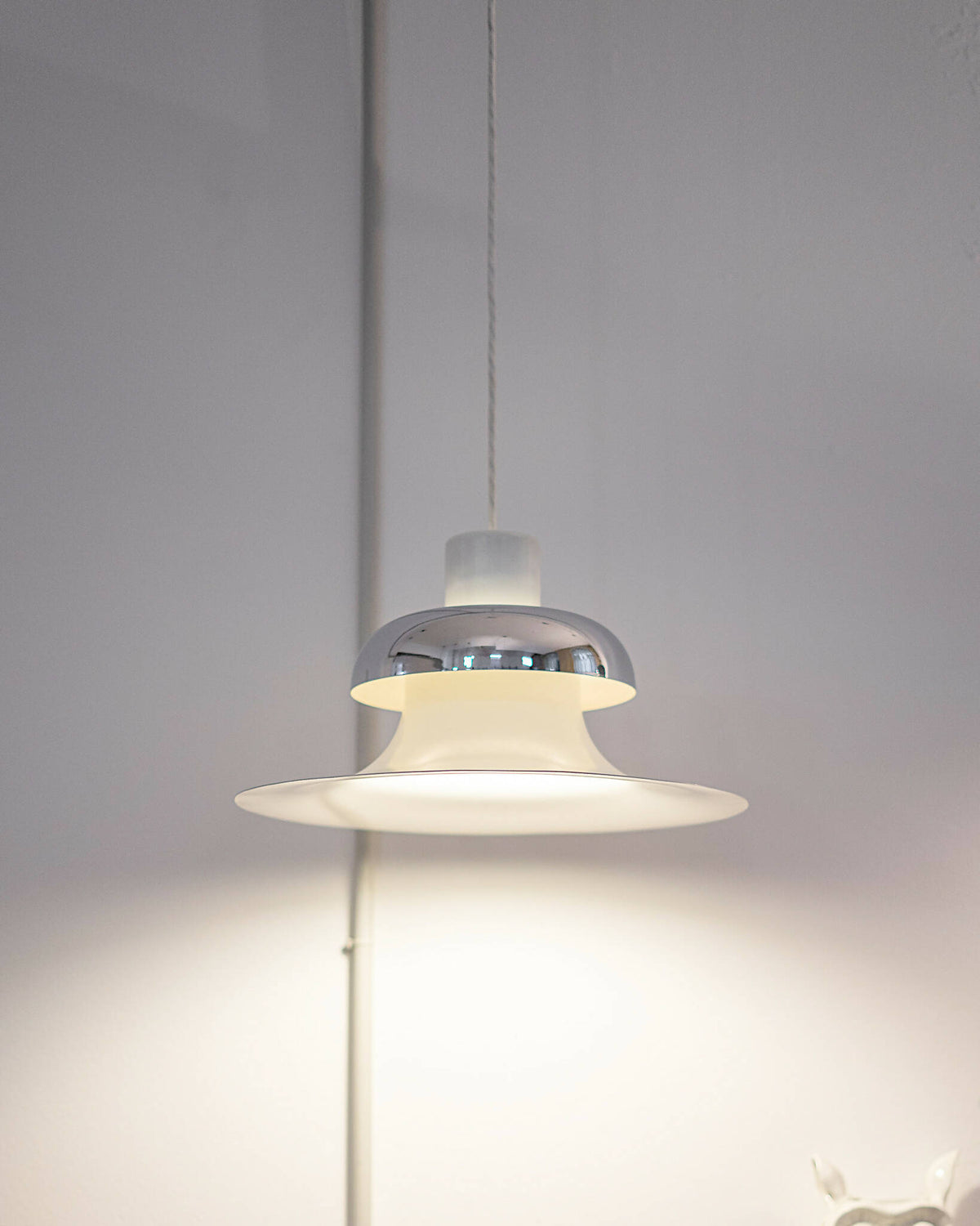 Oplyst Mandalay pendellampe fra Louis Poulsen i hvid og krom, ideel til moderne og klassiske interiører. Shop Mandalay pendellampe fra Louis Poulsen I SPLISH.